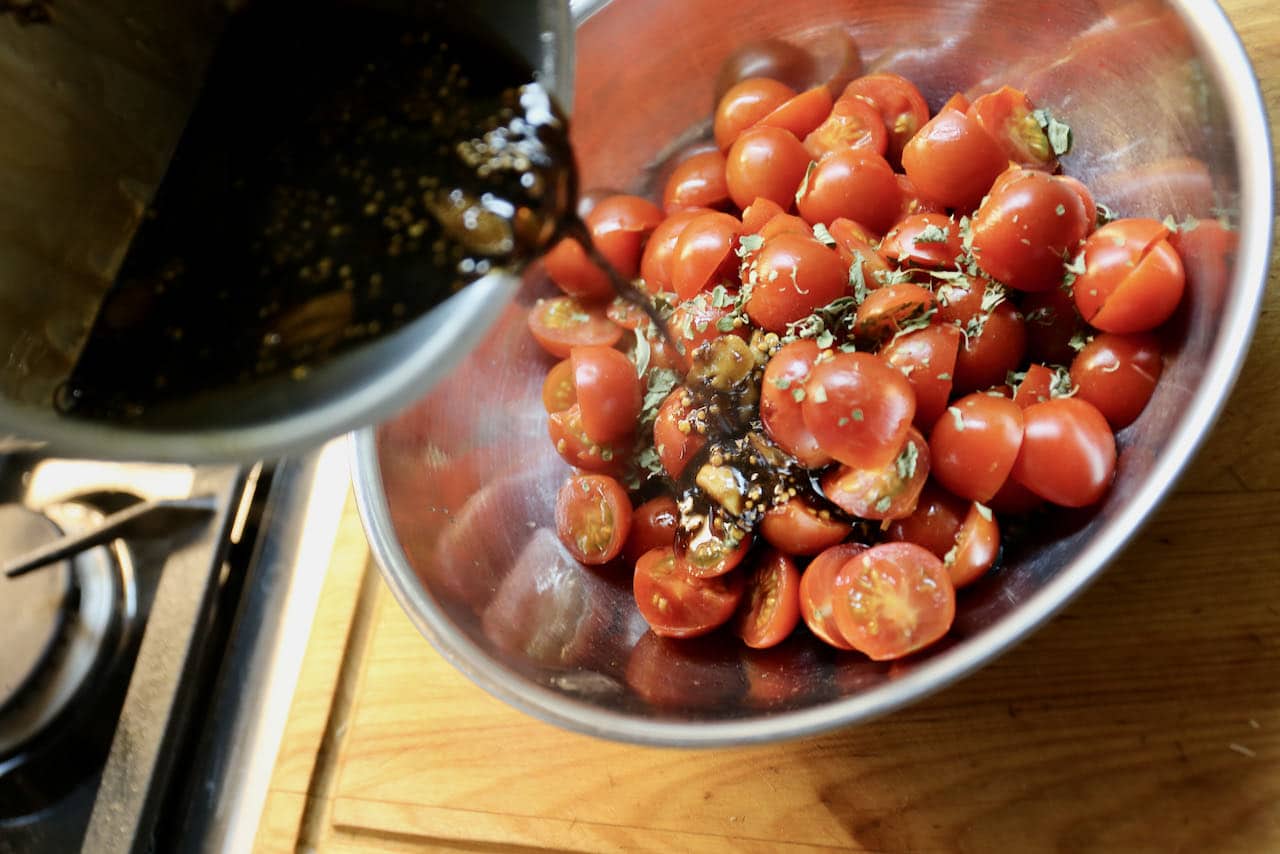 Pour spiced vinegar over sliced cherry tomatoes.