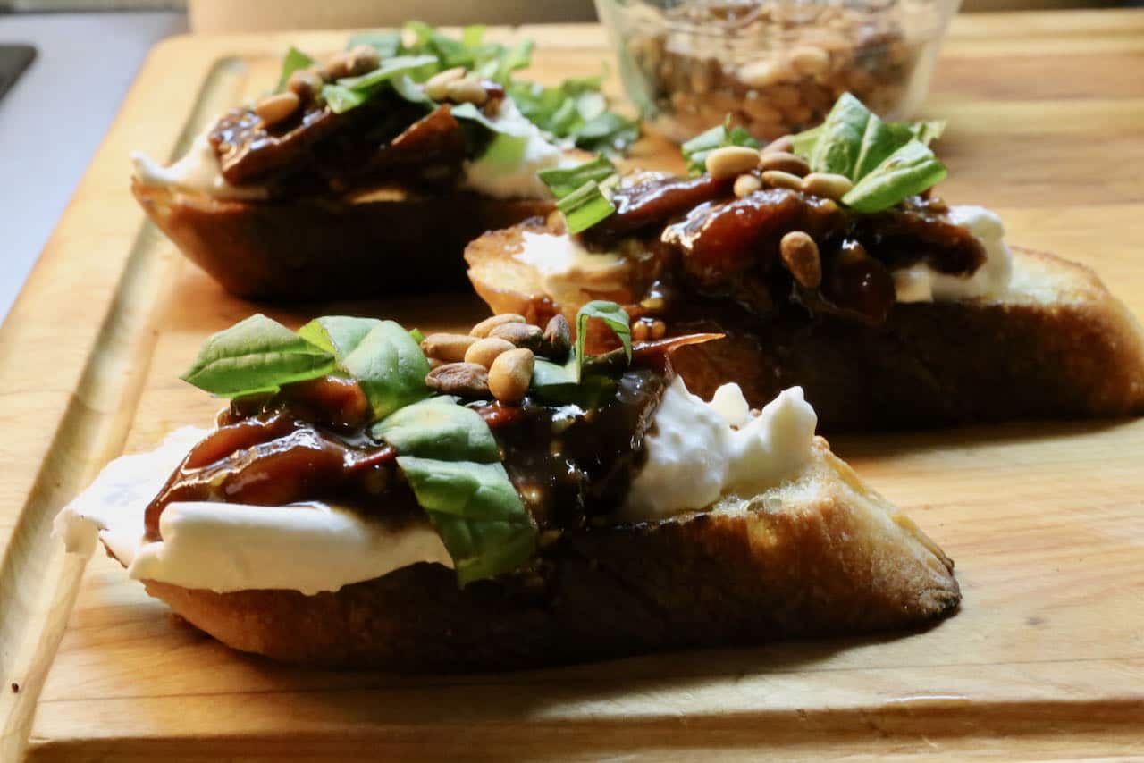 Our easy Burrata Bruschetta features creamy mozzarella cheese, tomato chutney, basil and pine nuts.