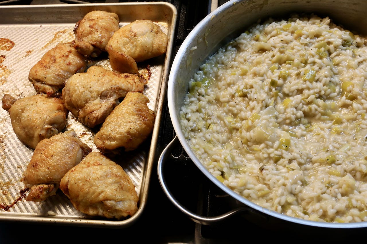 This risotto recipe is topped with roasted chicken thighs featuring a crispy spiced skin.