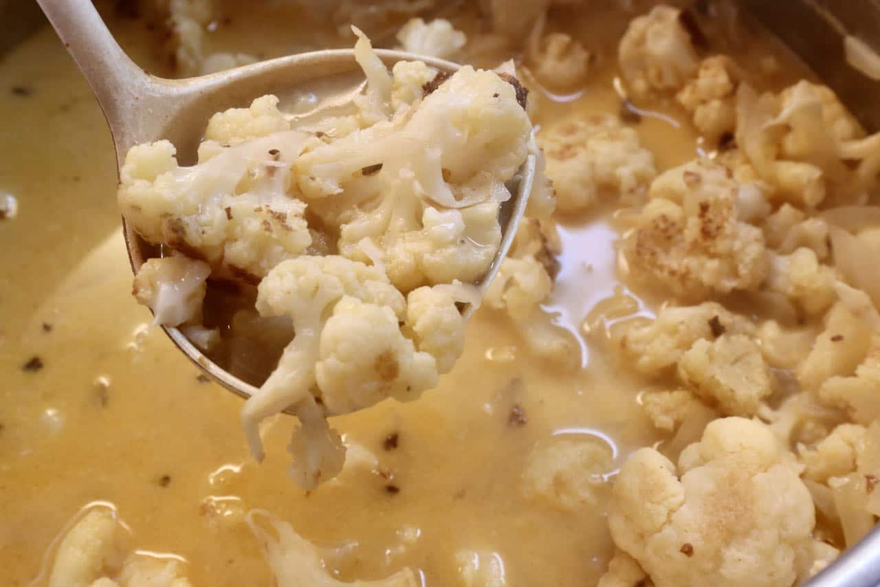 Once the Vegan Cauliflower Soup has cooked use a ladle to transfer to a blender.