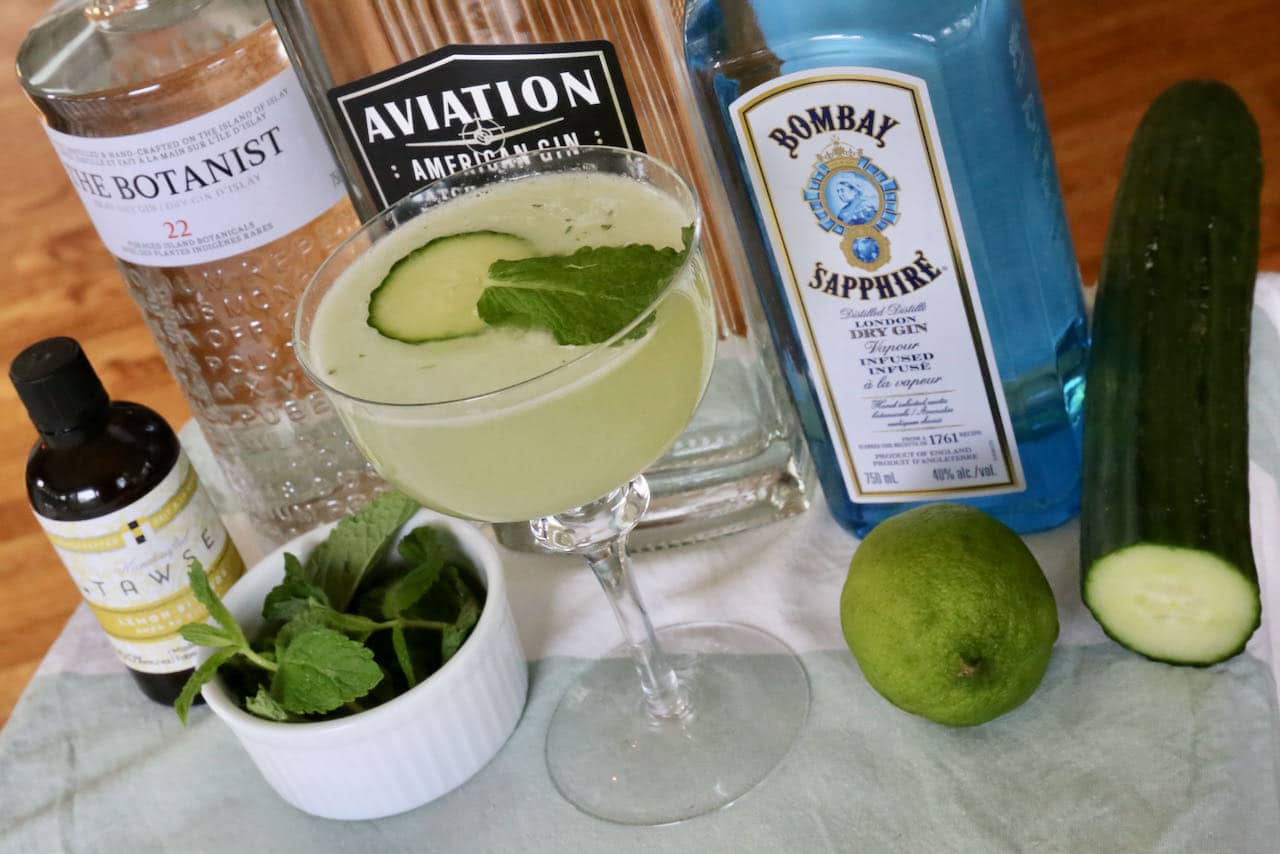 Garnish the cocktail with a slice of cucumber and fresh mint leaf.