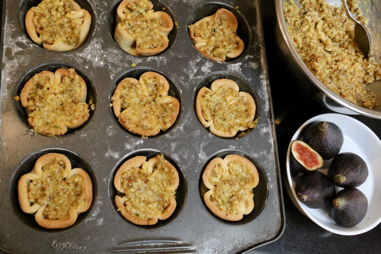 Fill par baked tartlets with pistachio frangipane.