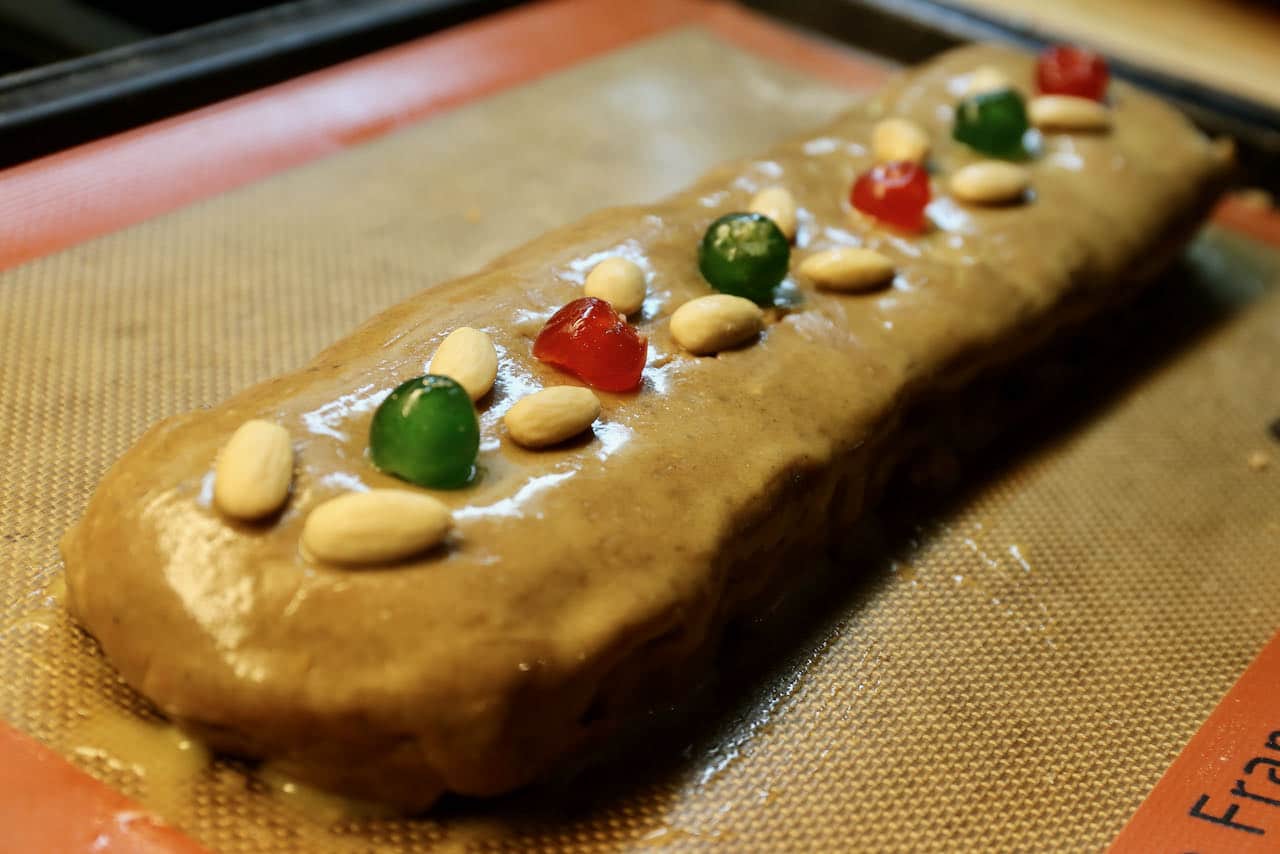 Wash Gevulde Speculaas exterior with egg wash and top with blanched almonds and glace cherries.