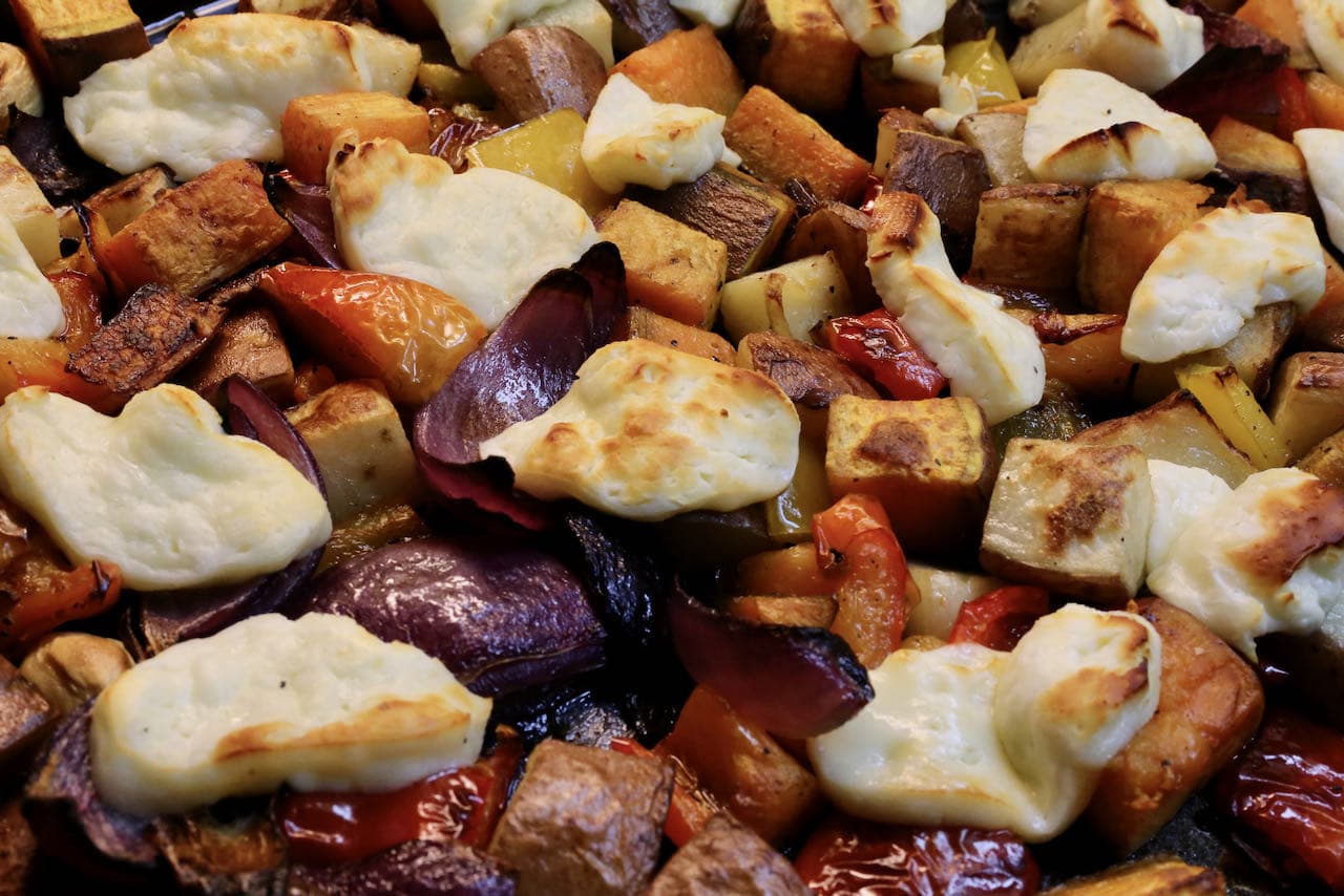 Oven Baked Halloumi is finished cooking one the cheese has browned and the roasted vegetables are crispy.