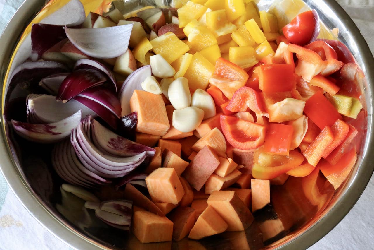 In a large bowl toss together the chopped vegetables with garlic, olive oil, salt and pepper. 