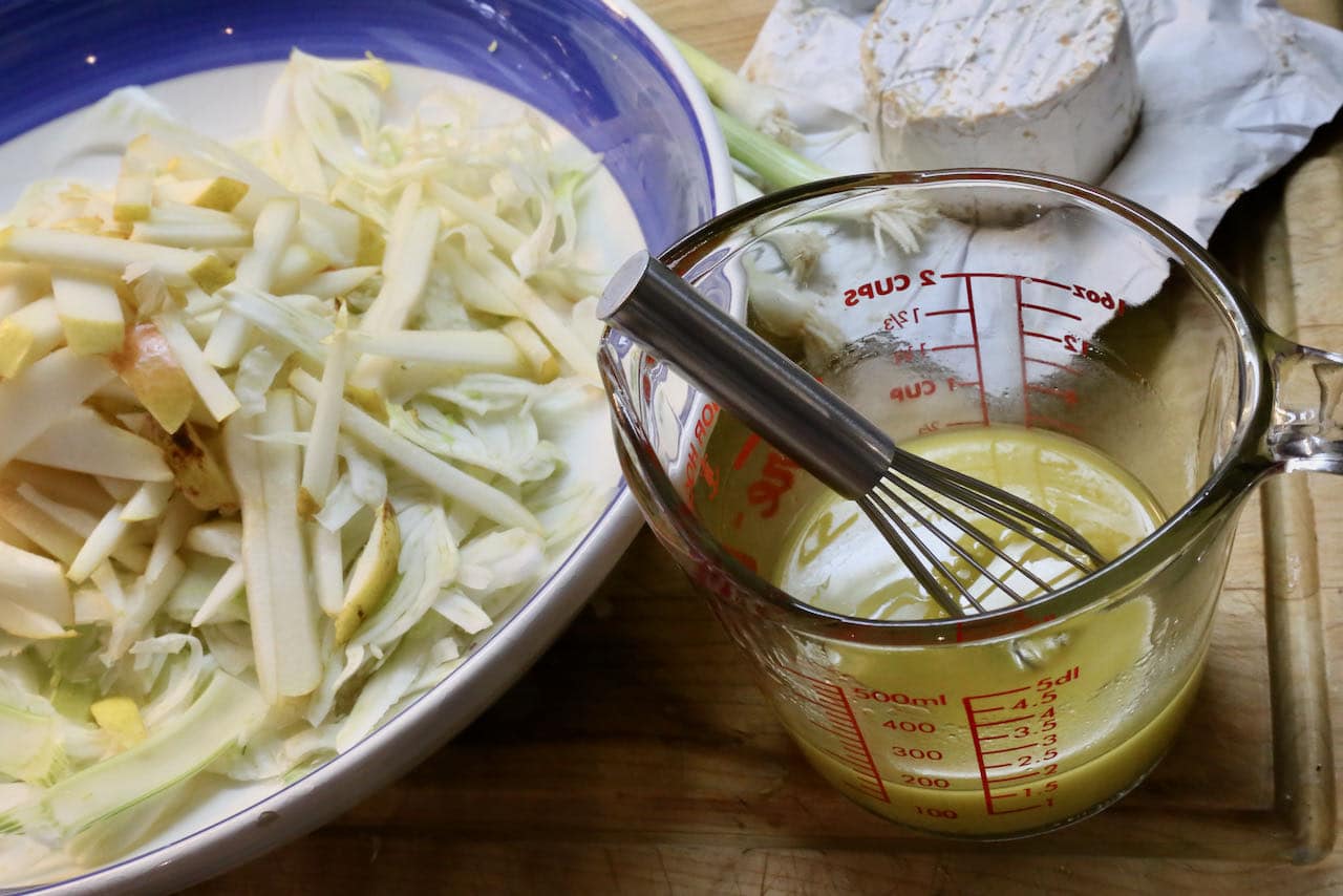Toss sliced fennel and julienned pear in honey lemon salad vinaigrette dressing.