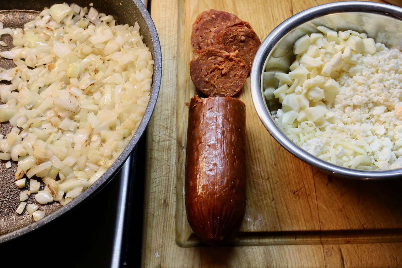 Traditional Peynirli Pide filling features sauteed onions, shredded cheese and Turkish sausage.