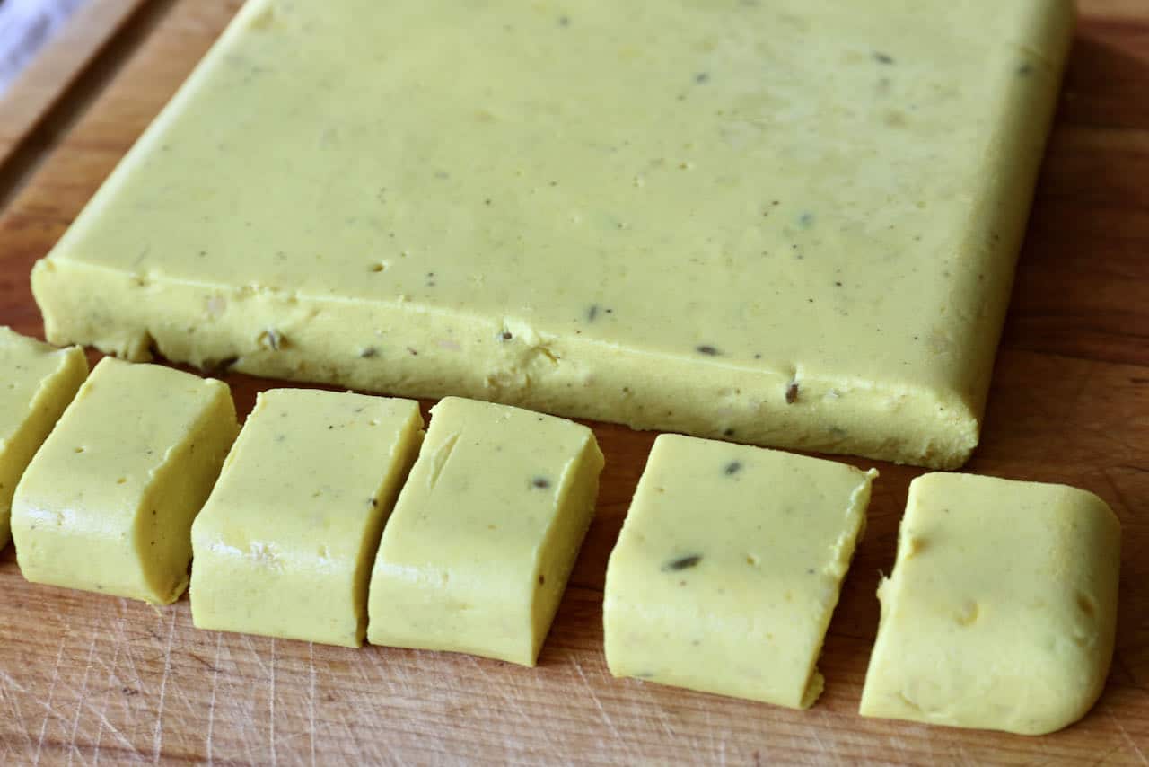 Slice cold chickpea dumplings into squares with a sharp knife.