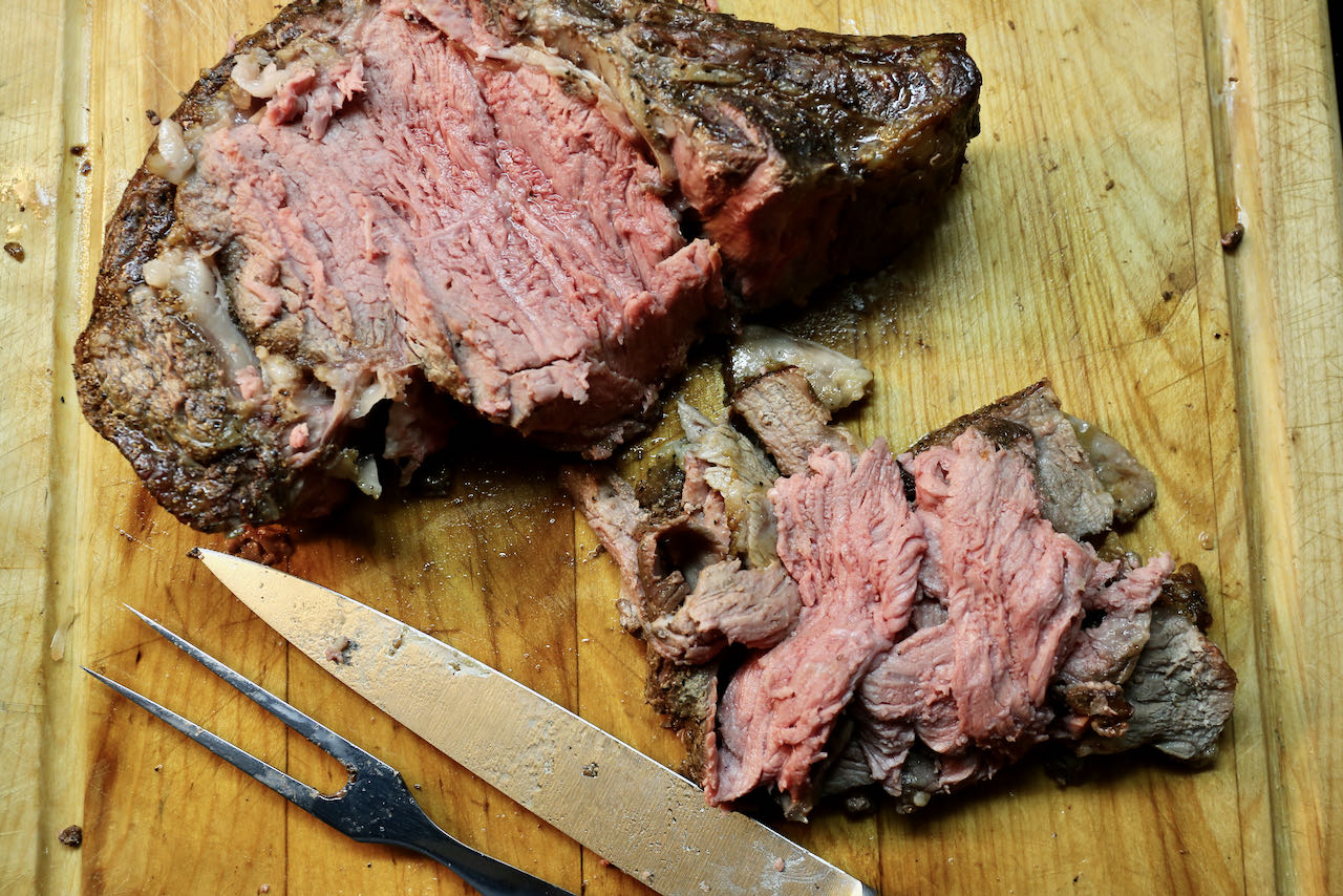 Roast the prime rib until medium rare then thinly slice.