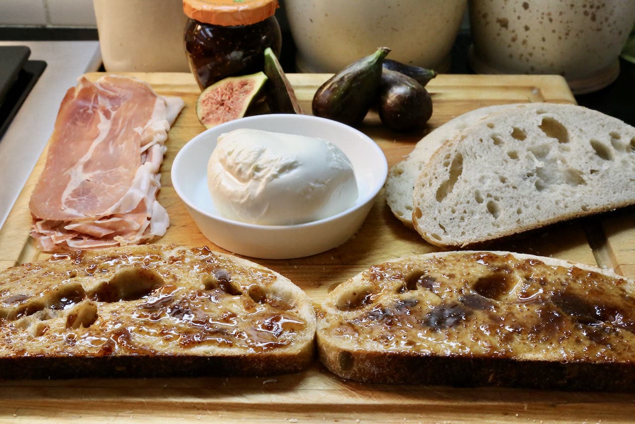 Slather sourdough bread slices with fig jam.