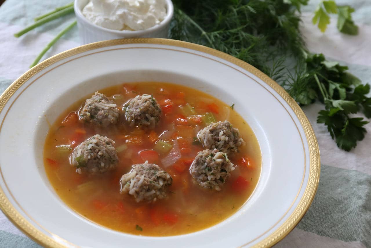 Serve homemade Ciorba de Perisoare at a Romanian-themed dinner party for a crowd.