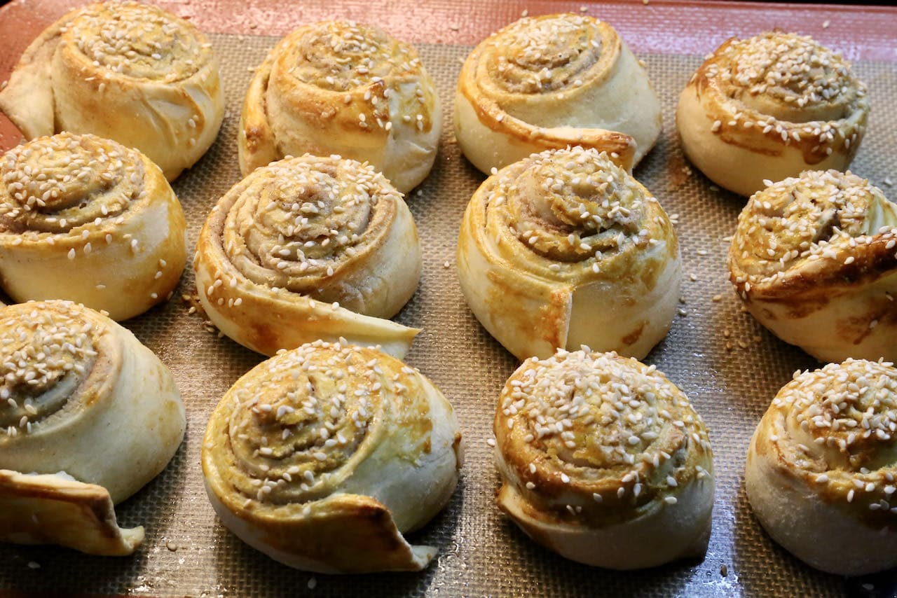Tahini Rolls are finished baking once they are golden brown and have a crunchy exterior.