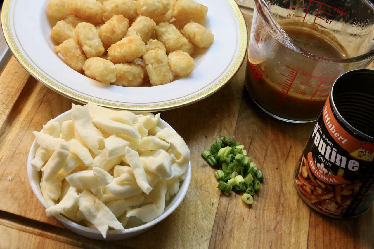Poutine Assembly: McCain Tater Tots are topped with cheese curds, hot brown gravy and sliced scallions or chives.