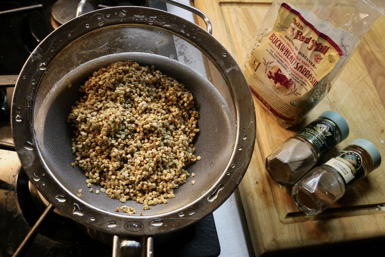 Wash and strain buckwheat groats in a sieve before cooking.
