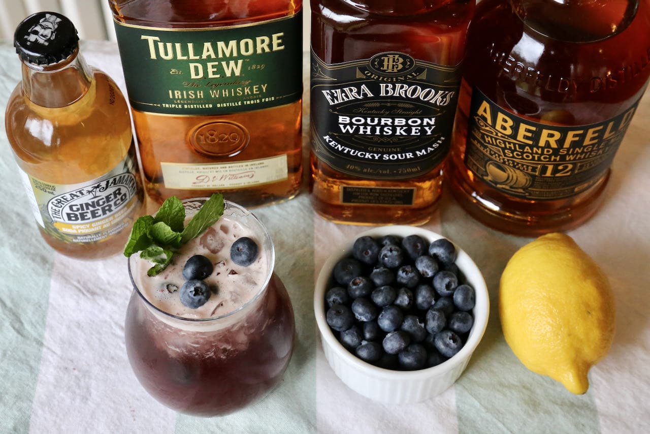 Our Blueberry Buck cocktail is garnished with a mint sprig and fresh blueberries.