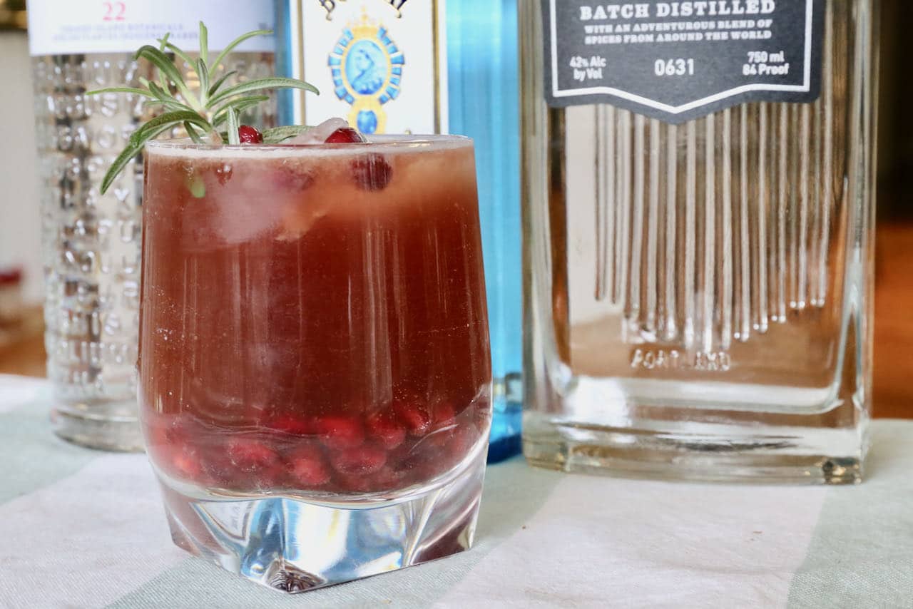 Our Pomegranate Gin Fizz recipe is garnished with pomegranate seeds and rosemary sprig.