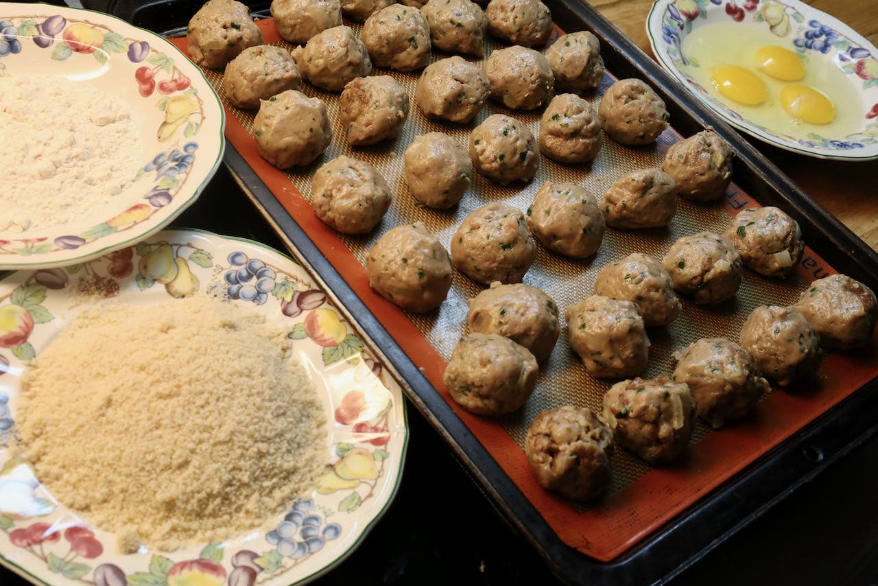 Dip bitterballen into a flour, bread crumbs and beaten eggs.