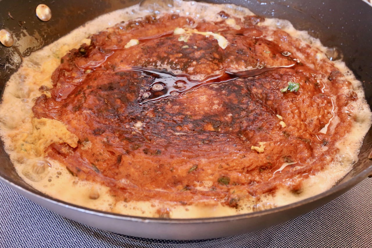 Flip Chicken Omelet in the wok once the exterior has browned and is crispy.