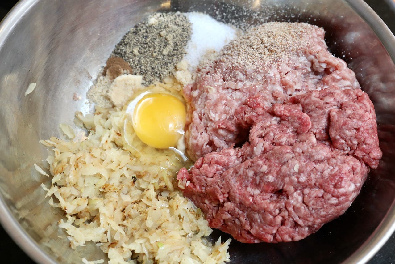 In a large bowl mix ground meat, onions, egg and spices. 