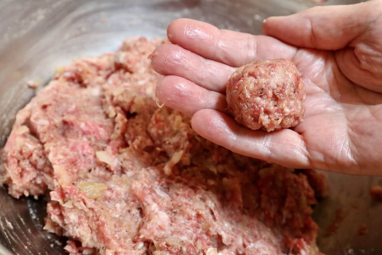 Use your hands to roll Köttbullar into ping pong ball-sized meatballs.