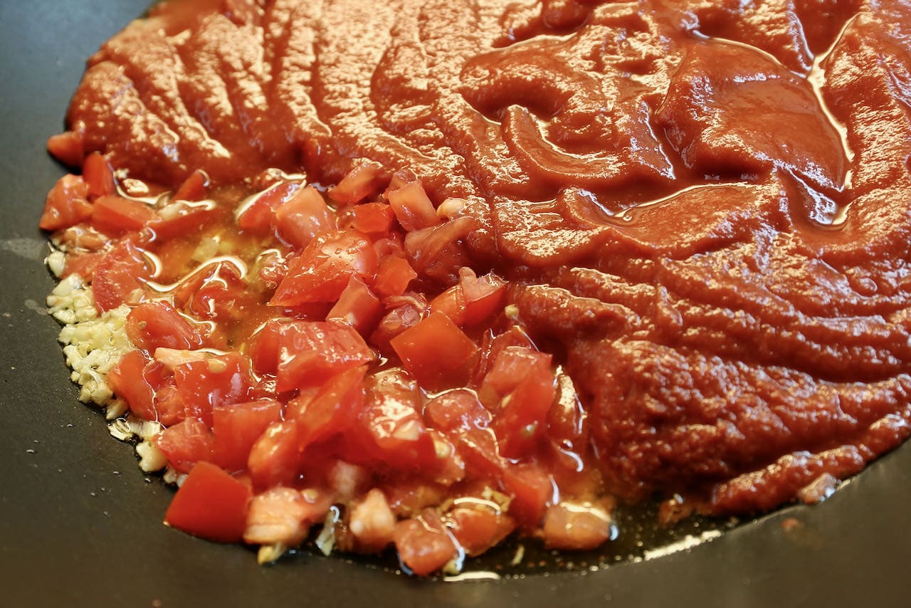 Homemade Maccheroni al Ferretto ragu sauce features olive oil, garlic, tomatoes, passata and red wine.