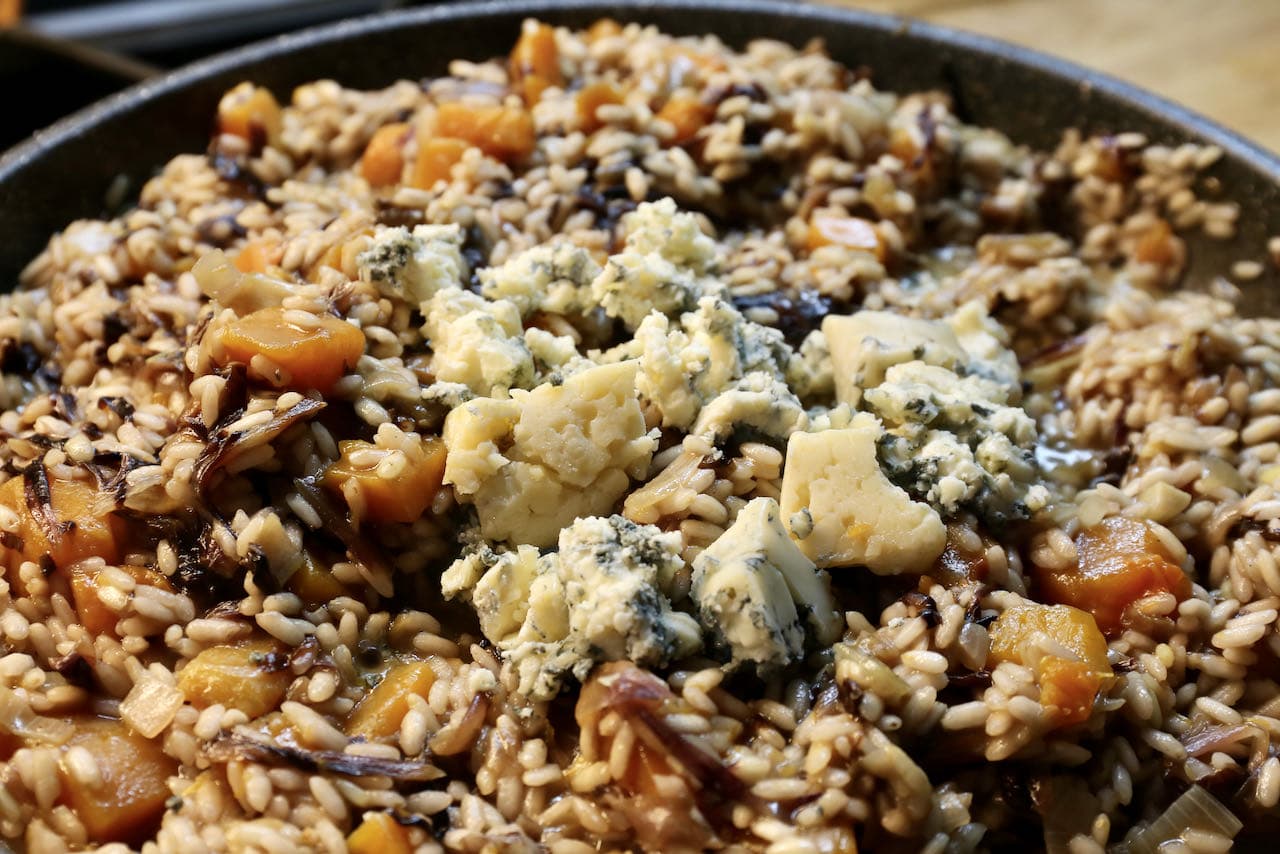 Once the rice is al dente stir in crumbled gorgonzola cheese to the Risotto al Radicchio.