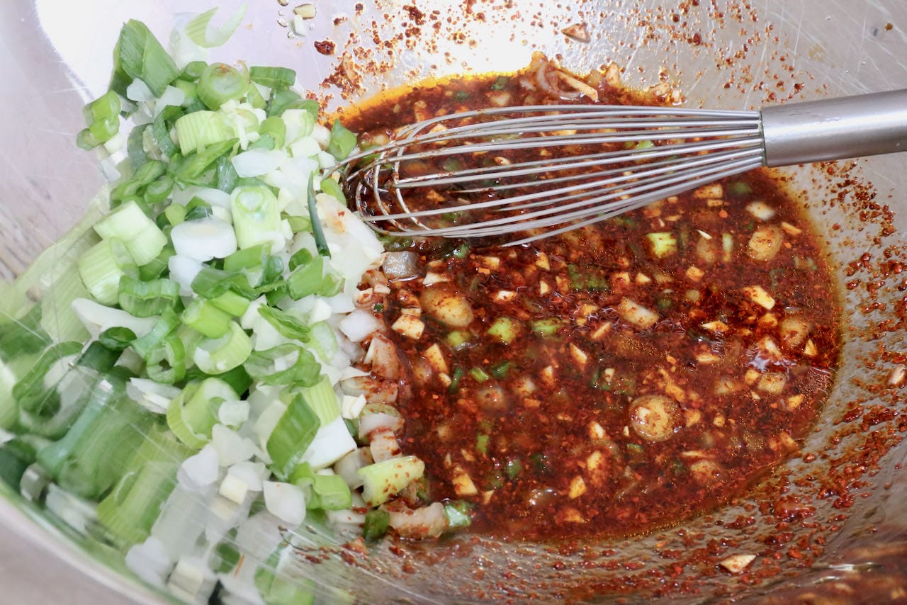 This easy sweet and sour salad dressing features garlic, scallions, soy sauce, lime and Korean Hot Pepper Flakes.