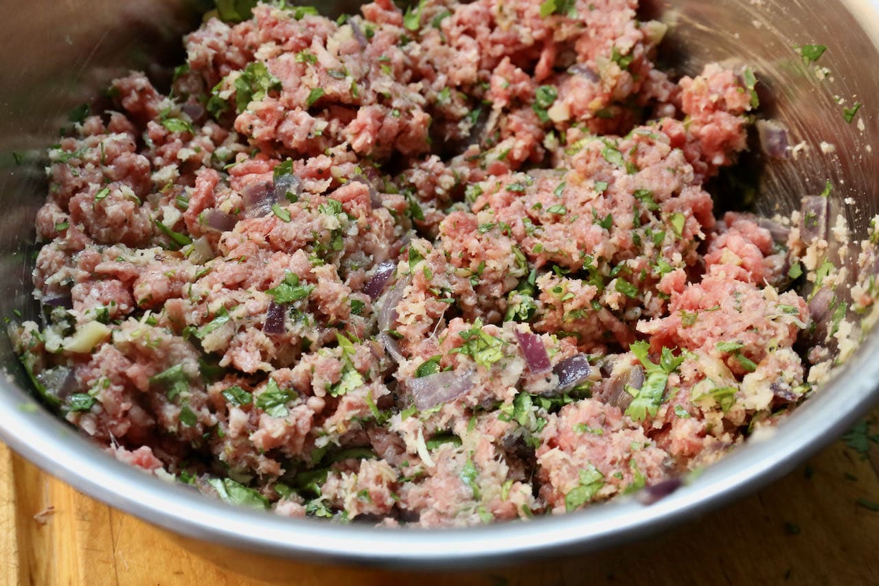 Combine Albondigas Enchipotladas meatball ingredients in a mixing bowl.