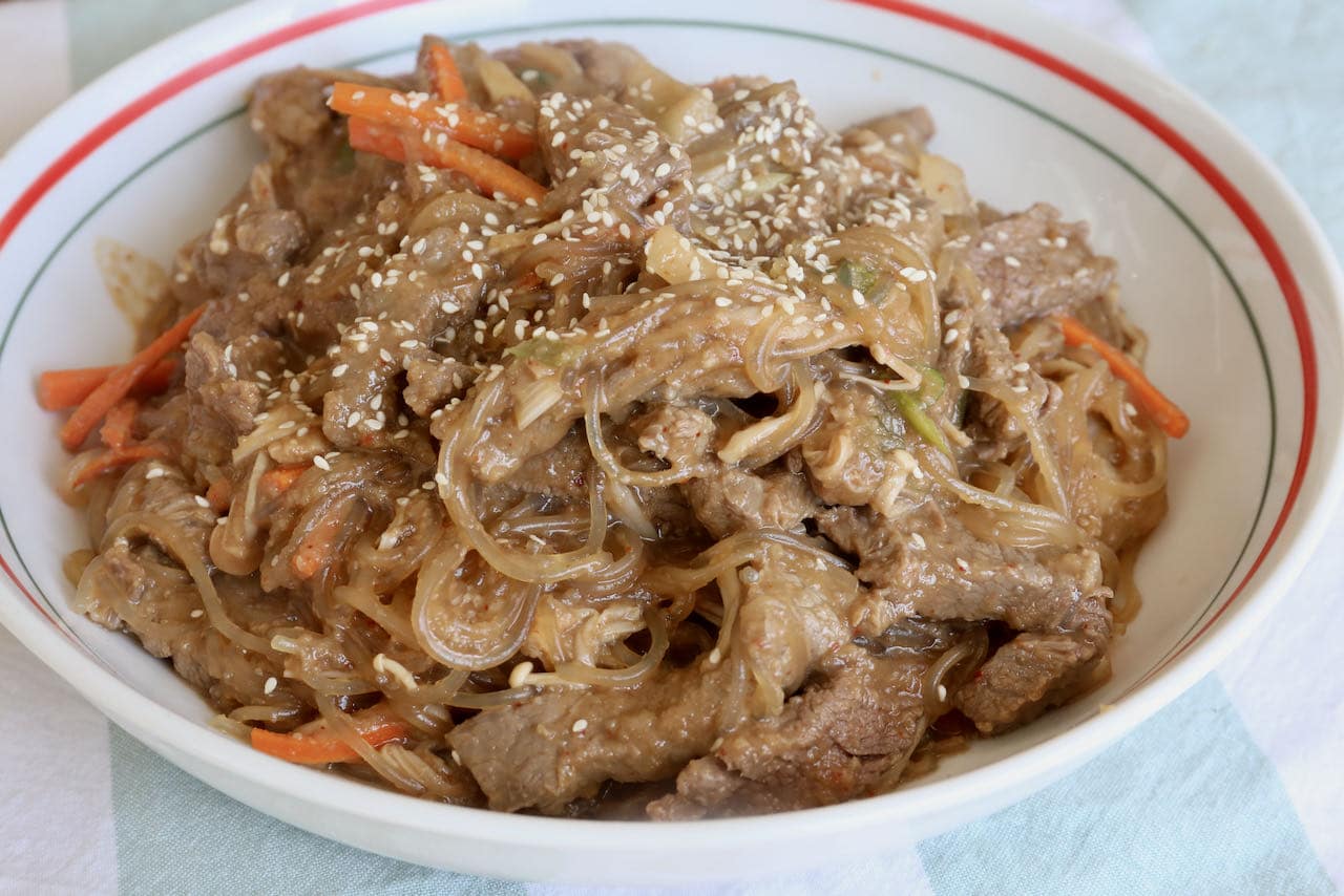 Serve Beef Bulgogi Noodles out of a large serving bowl sprinkled with sesame seeds. 