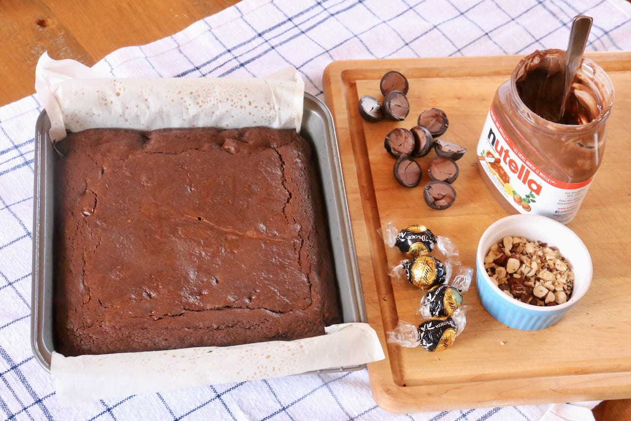 Lindt Chocolate Cake Assembly: Lindor Truffles, Nutella Chocolate Hazelnut Spread & Roasted Hazelnuts. 