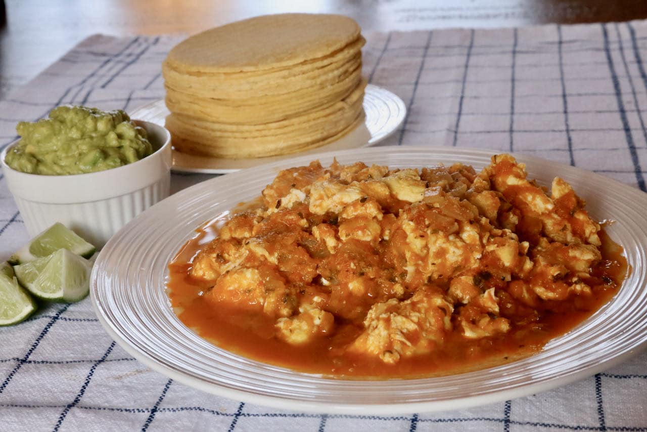 Serve Salsa de Huevo with guacamole, tortilla and lime.