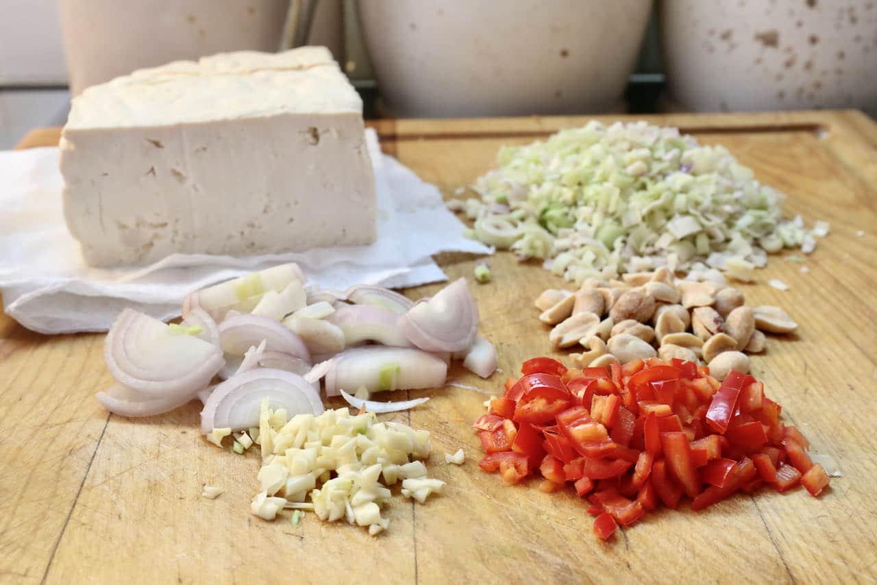 Prepare homemade Vietnamese Tofu ingredients by chopping shallots, garlic, chili and lemongrass. 