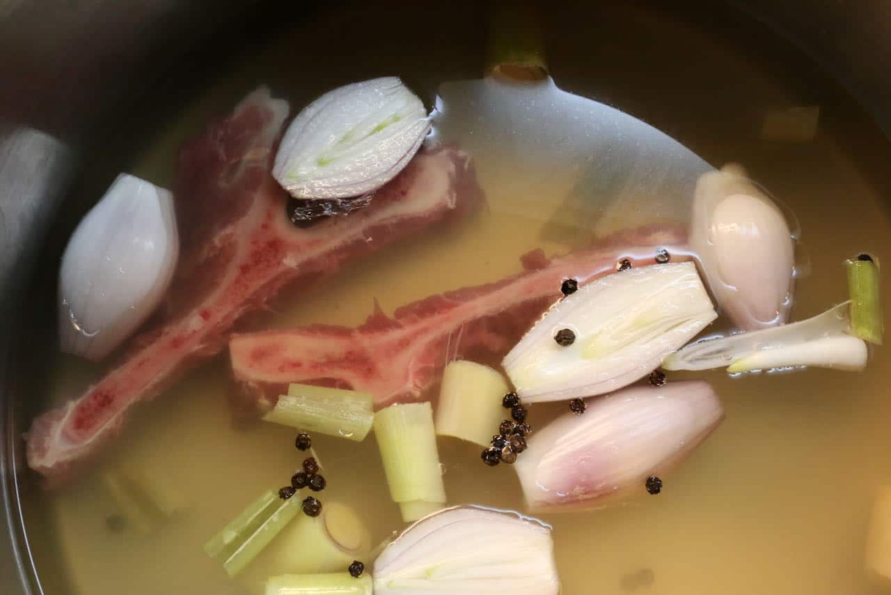 Burmese Khow Suey: In a large pot prepare broth with pork bones, shallots, lemongrass and peppercorns.