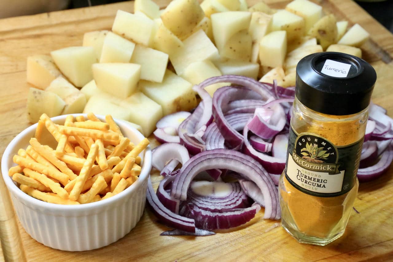 Healthy vegetarian Aloo Fry features yukon gold potatoes, ground turmeric, red onions and chow mein noodles. 