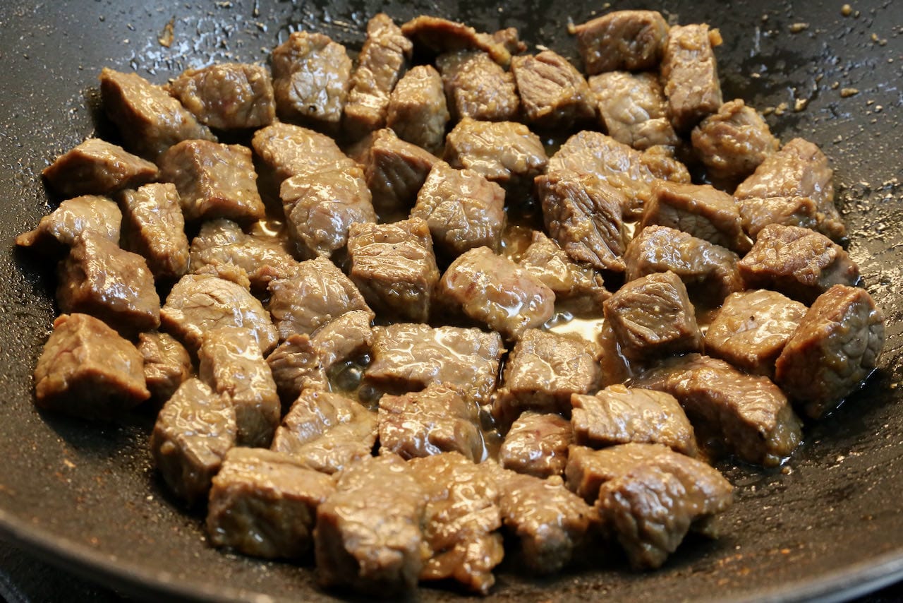 Vietnamese Shaking Beef is prepared in a large wok.