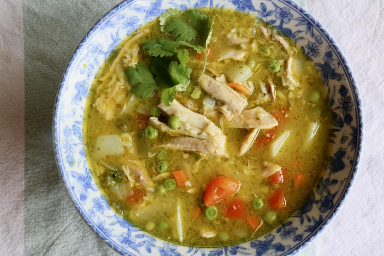 Garnish traditional Aguadito de Pollo with cilantro.