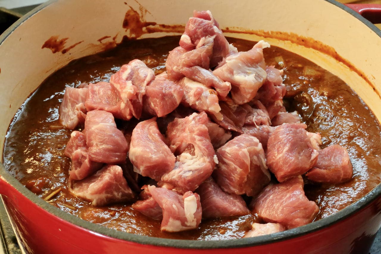 Asado de Boda features chunks of pork shoulder cooked in red chile sauce.