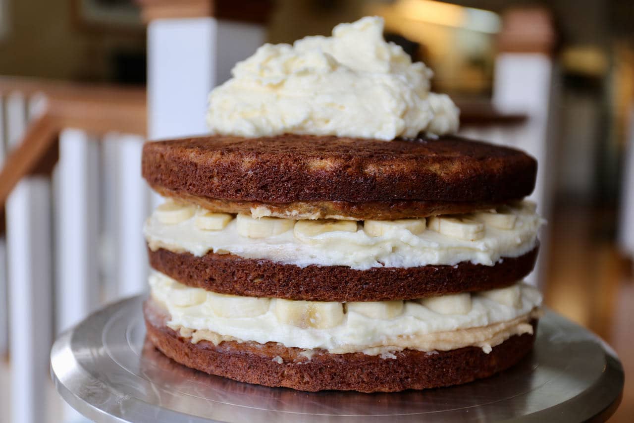 Our layered Banoffee cake is filled with homemade caramel sauce, cream cheese frosting and sliced bananas.