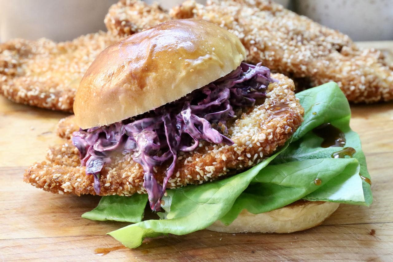 Our crispy Chicken Schnitzel Sandwich recipe features red cabbage coleslaw, bbq sauce and fresh lettuce.