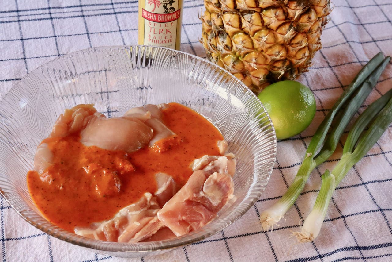 Our Jamaican Burger recipe features marinated chicken thighs, spicy Jerk seasoning, grilled pineapple and fried plantain. 