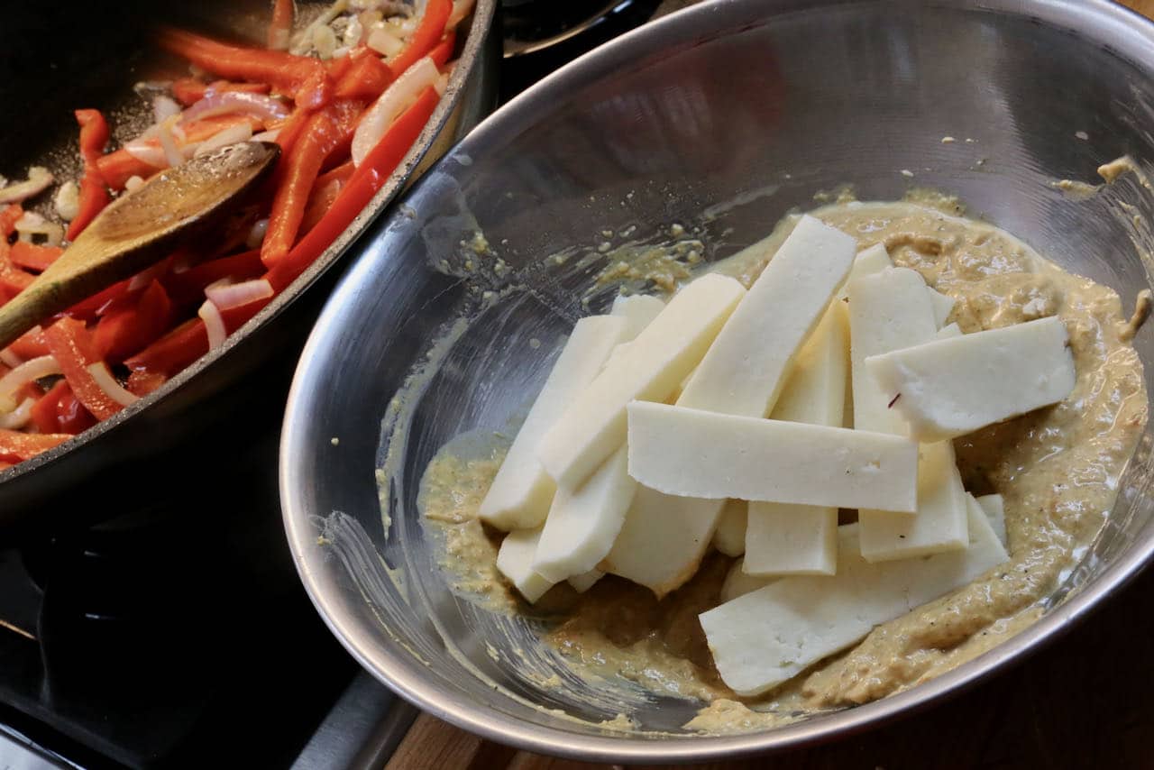 Toss paneer slices in marinade. In a skillet saute onions and red bell peppers.
