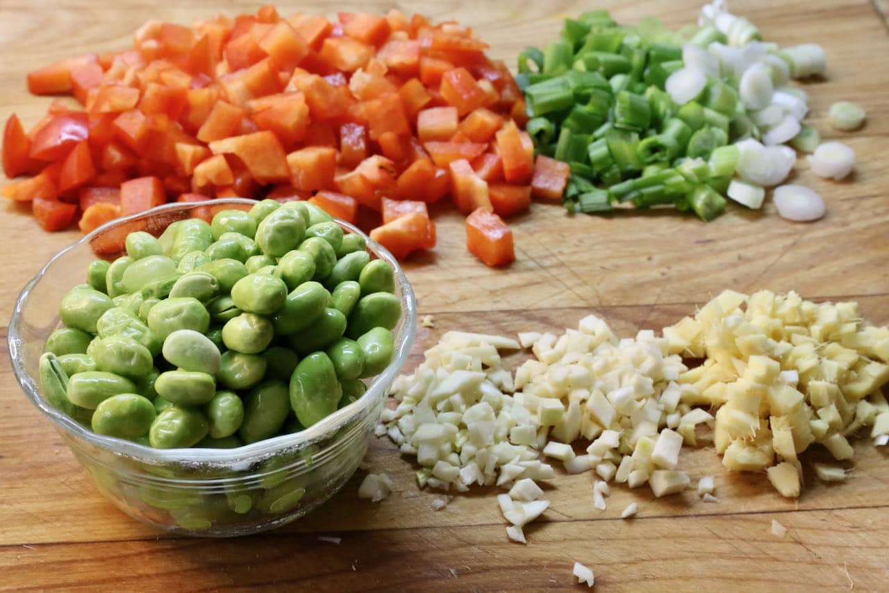 Homemade Quinoa Chaufa features bell peppers, scallions, garlic, ginger and edamame.