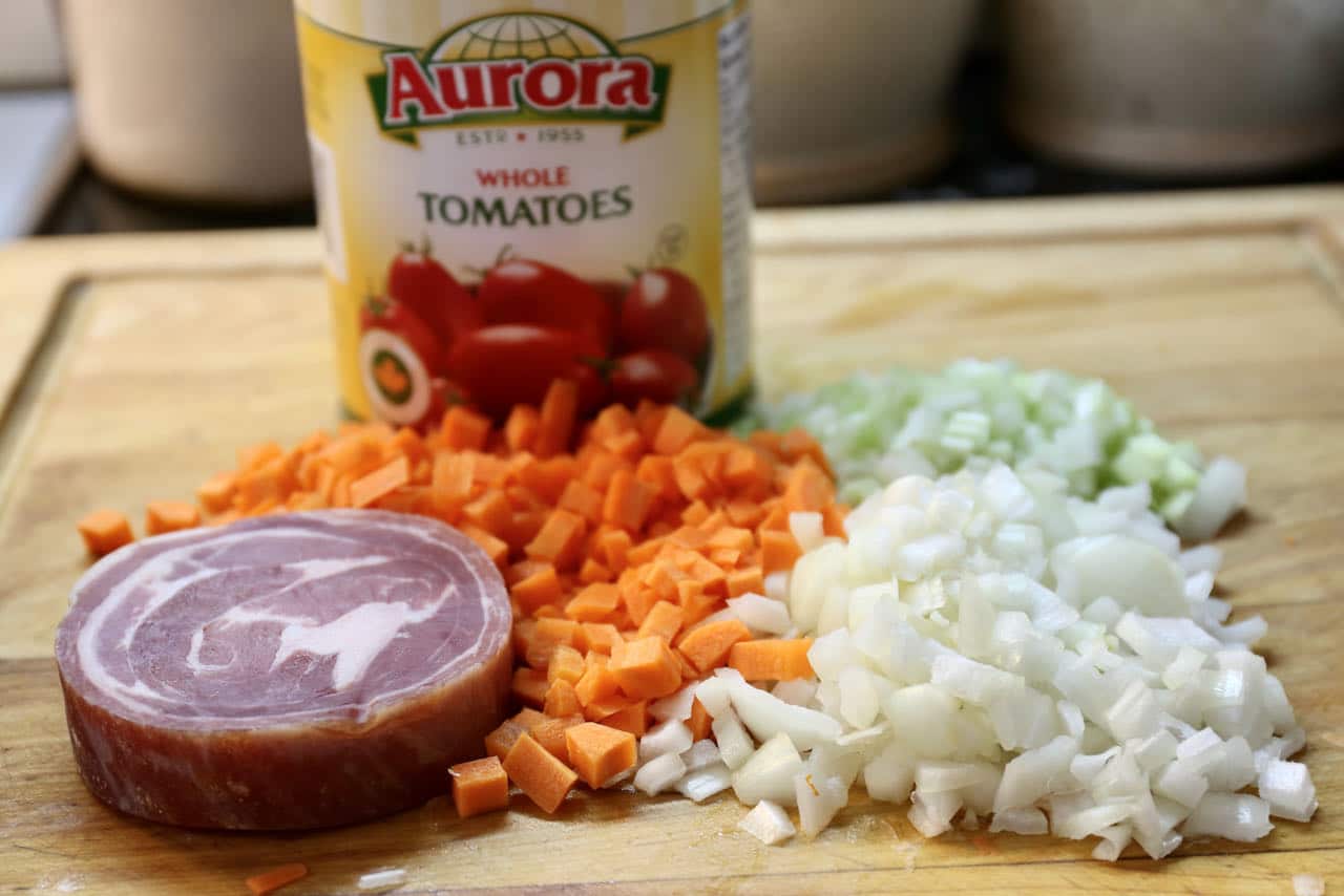 Bolognese sauce is prepared with onion, celery, carrot, tomatoes and pancetta.