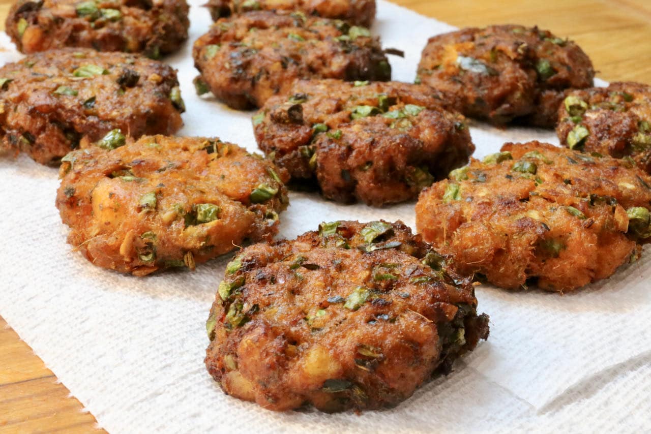 Drain Tod Mun Pla on paper towels after deep frying.