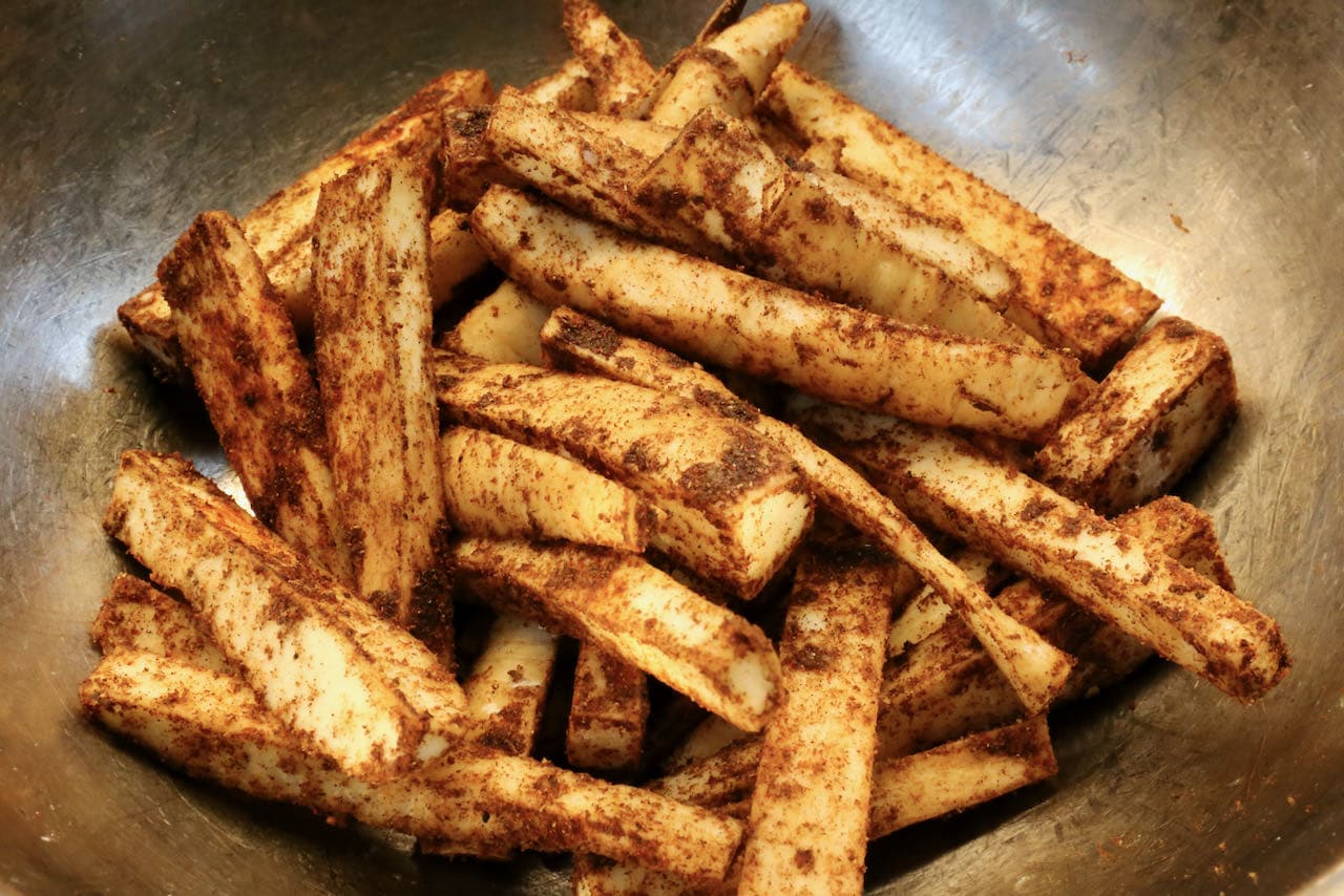 Toss sliced parsnips in spice mix.
