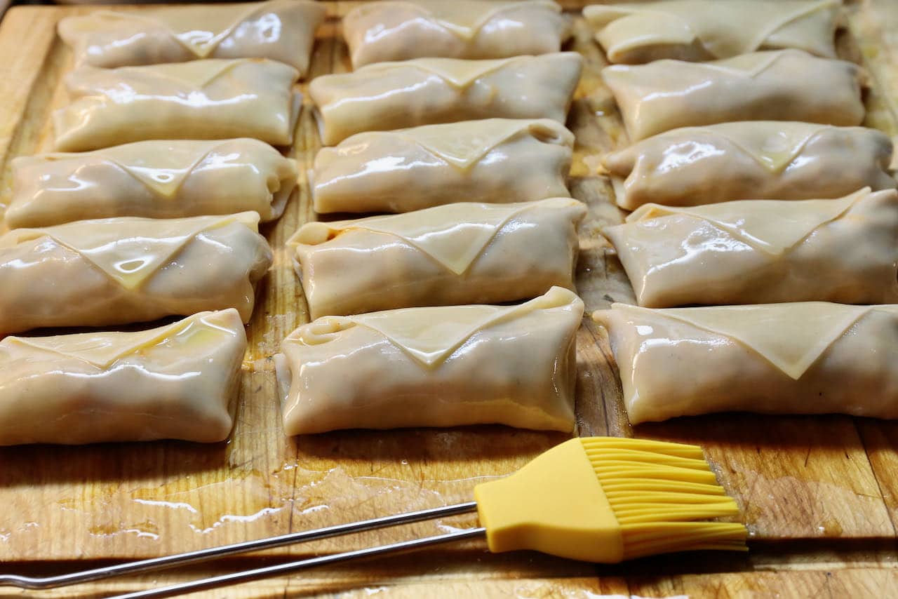 Brush Air Fryer Pizza Rolls with olive oil.