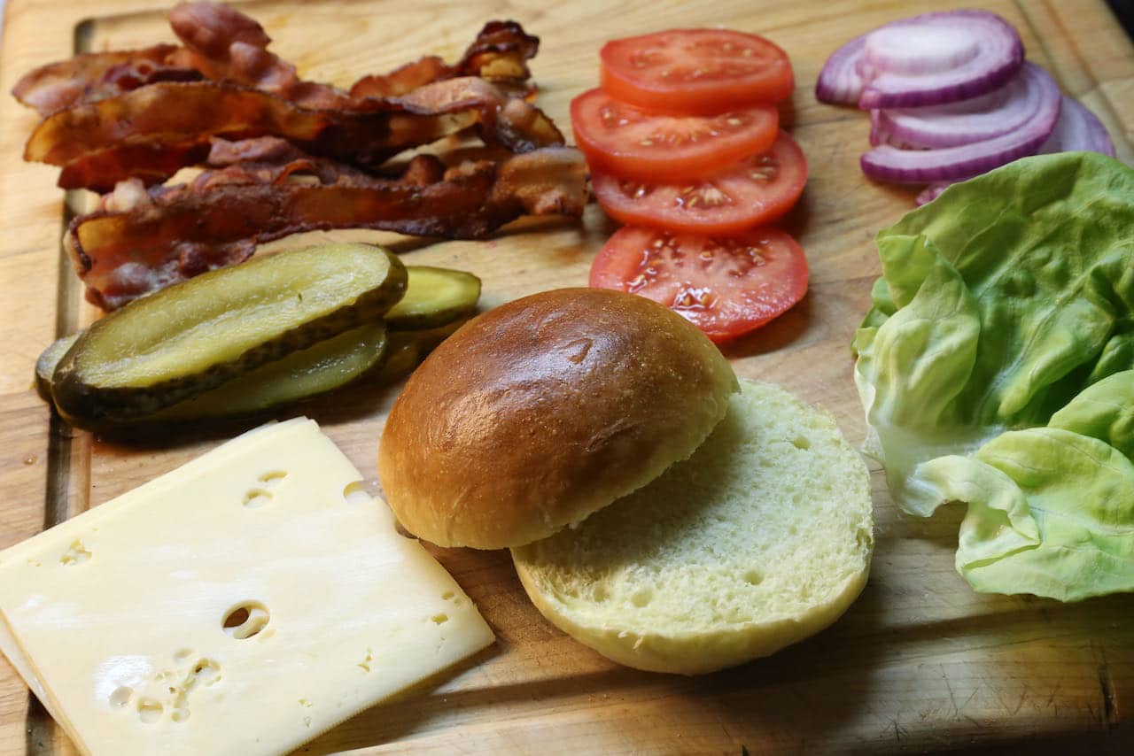 Our favourite burger toppings include cheese slices, pickles, crispy bacon, tomatoes, onions and lettuce.