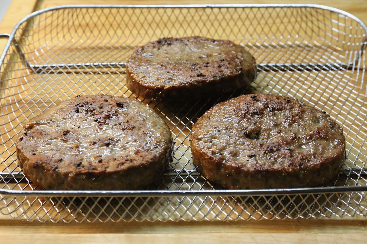 Remove frozen burger patties from your air fryer once they are browned and cooked through, approximately 15-20 minutes. 