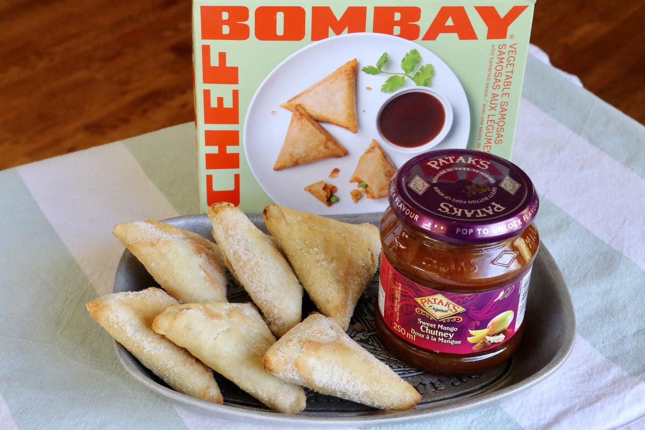 Easy Frozen Air Fryer Samosas feature store bought Indian pastries and chutney for dipping.