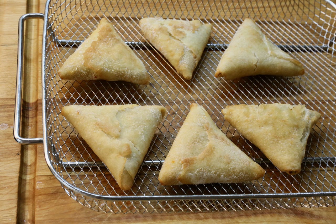 Place frozen samosas in an air fryer basket.